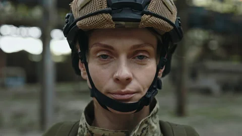 Soldier looking at camera with serious face on plant Stock Footage 198353355