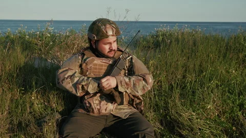 Soldier Looking For Something Inside His Uniform Stock Footage 310687559