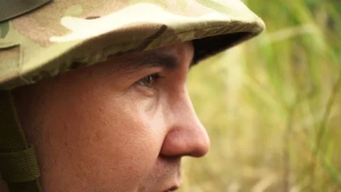 Soldier looking through binoculars lying in ambush Stock Footage 159707745