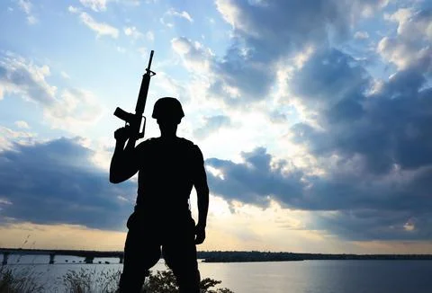 Soldier with machine gun patrolling outdoors. Military service Stock Photos