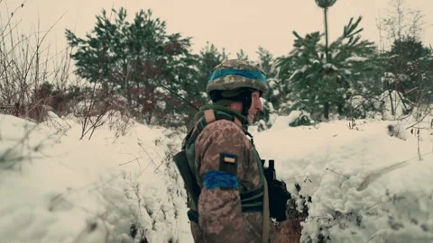 A soldier with a machine gun walks along the trench. Stock Footage 260320812