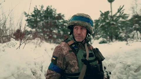 A soldier with a machine gun walks along the trench. Stock Footage 260320824