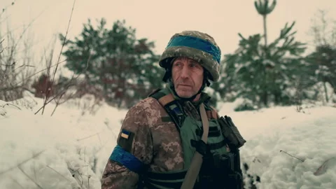A soldier with a machine gun walks along the trench. Stock Footage 260320830