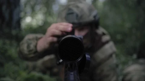 Premium Photo  Camouflaged sniper in the forest in ambush. military man  aiming a gun, a rifle at the enemy in nature