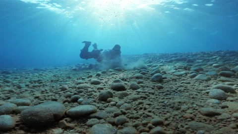 Soldier moves big stone under water Stock Footage 252010592