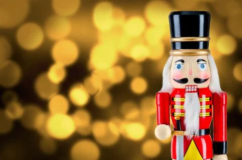 Soldier nutcracker statue standing in front of Christmas lights Stock Photos
