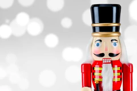 Soldier nutcracker statue standing in front of Christmas lights Stock Photos