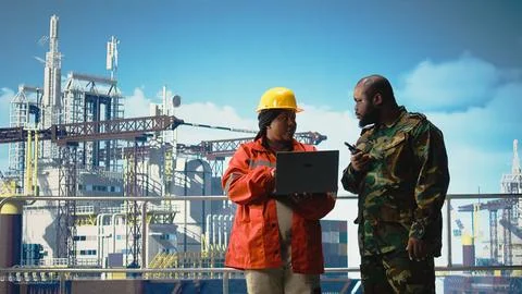 Soldier on offshore platform transmitting security report with walkie talkie Stock Photos