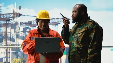 Soldier on offshore platform transmitting security report with walkie talkie Stock Photos