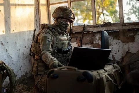 Soldier operates a drone control console. Military personnel is carrying out  Stock Photos