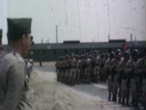 Soldier Platoons Marching Down Army Base Road While General Watches - Vintage Stock Footage 78924566