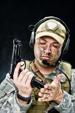 Soldier posing with a gun Stock Photos