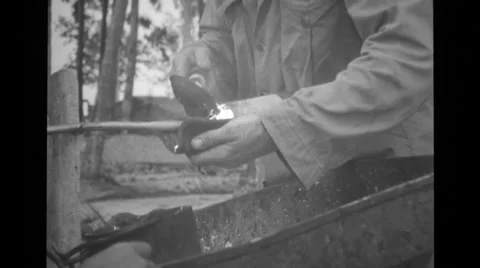 Soldier pouring a protective layer on a cable Stock Footage 37593545