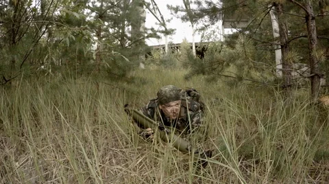 Soldier prepares RPG lying in the grass, and then aiming Stock Footage 68451139
