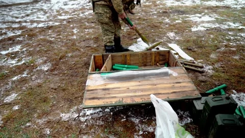 A soldier prepares shells for firing a grenade launcher at a military training Stock Footage 290372956
