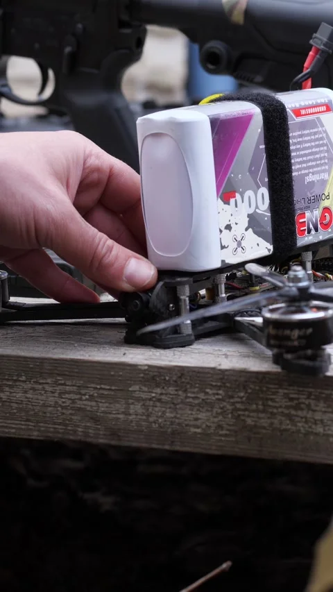 Soldier preparing FPV kamikaze drone with powerful battery Stock Footage 333612791