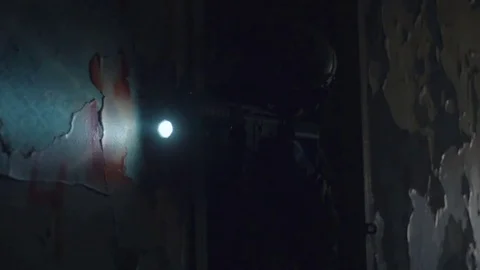 Soldier in protective helmet looking in sight on gun with flashlight in dark Stock Footage 82491614
