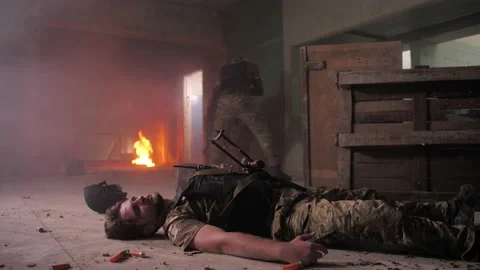 Soldier pulling wounded comrade from battlefield Stock Footage 138145083