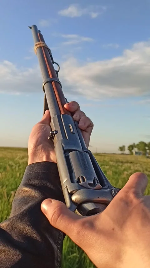 A soldier pulls the trigger of a musket to shoot at a man paragliding 動画素材 236168489