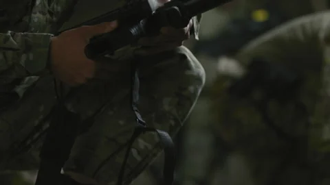 Soldier putting on silencer on weapon closeup Stock Footage 275094110
