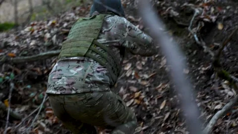 Soldier reaching position and taking cover with rifle during combat training Stock Footage 320576615