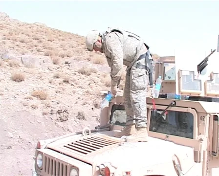 Soldier refreshing Humvee's engine Stock Footage 996167