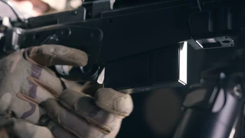A soldier is reloading their weapon while in a during a mission Stock Footage 294096741