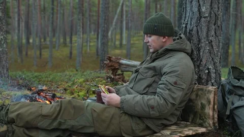 Soldier resting in the forest Stockbeeldmateriaal 297495544