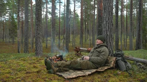 A soldier rests in the forest Stockbeeldmateriaal 297179737