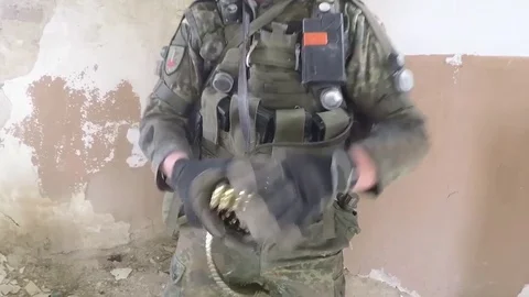 Soldier rolling ammunition belt for loading into machine gun 動画素材 93390266
