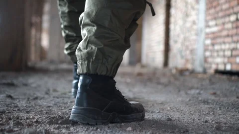 Soldier running down the hallway of a destroyed building, military scene Stock Footage 101690723