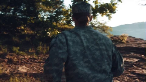 A Soldier Runs Through A Forest Stock Footage 87429589