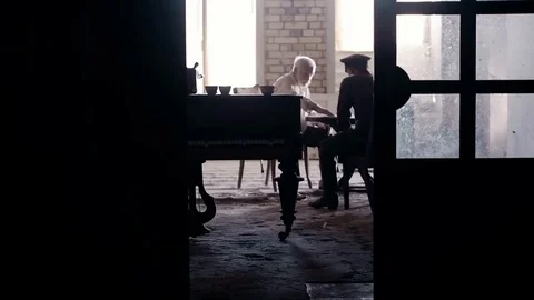 Soldier of the Russian army interrogates a suspect, an elderly man with a beard Stock Footage 100372605