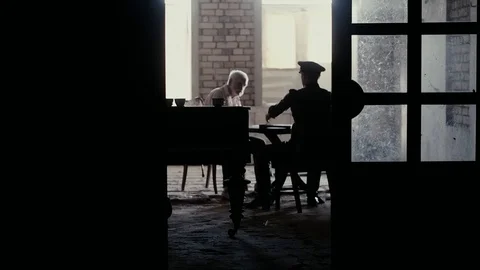 Soldier of the Russian army interrogates a suspect, an elderly man with a beard Stock Footage 100372606
