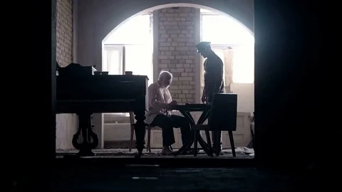 Soldier of the Russian army interrogates a suspect, an elderly man with a beard Stock Footage 100372624