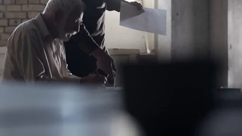 Soldier of the Russian army interrogates a suspect, an elderly man with a beard Stock Footage 100372676