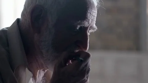 Soldier of the Russian army interrogates a suspect, an elderly man with a beard 動画素材 100372680