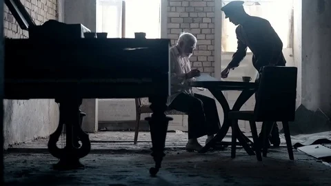 Soldier of the Russian army interrogates a suspect, an elderly man with a beard Video stock 100372691