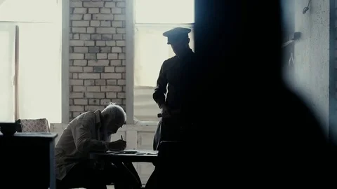 Soldier of the Russian army interrogates a suspect, an elderly man with a beard Stock Footage 100372739