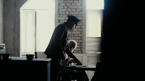 Soldier of the Russian army interrogates a suspect, an elderly man with a beard Video stock 100372740