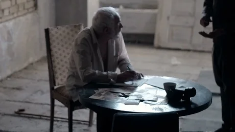 Soldier of the Russian army interrogates a suspect, an elderly man with a beard Stock Footage 100372752