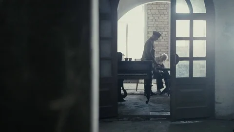 Soldier of the Russian army interrogates a suspect, an elderly man with a beard Video stock 100372868