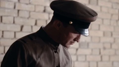 Soldier of the Russian army interrogates a suspect, an elderly man with a beard Stock Footage 100372885