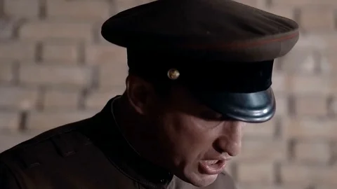 Soldier of the Russian army interrogates a suspect, an elderly man with a beard Video stock 100372916