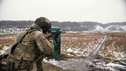 A soldier with a Russian patch on his helmet shoots live ammunition. Stock Footage 172243452