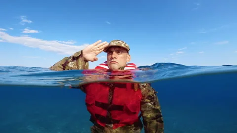 Soldier salutes at the ocean Stock Footage 266790764