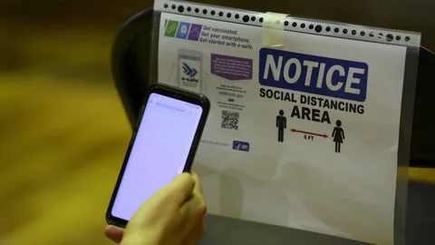 Soldier scanning QR code with Smartphone to register for Covid-19 vaccination Stock Footage 150351898