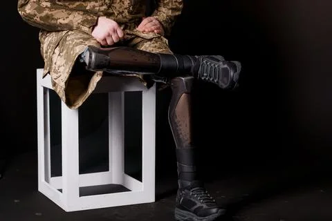 Soldier Seated with Advanced Bionic Leg Prosthesis, Showcasing Modern Techn.. Stock Photos