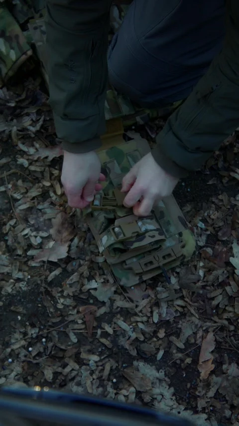 Soldier Securing Grenade Pouches on Tactical Belt Before Mission Stock Footage 337829520