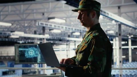 Soldier in server hub using laptop to deploy AI tech, modernizing defense Stock Footage 314803905